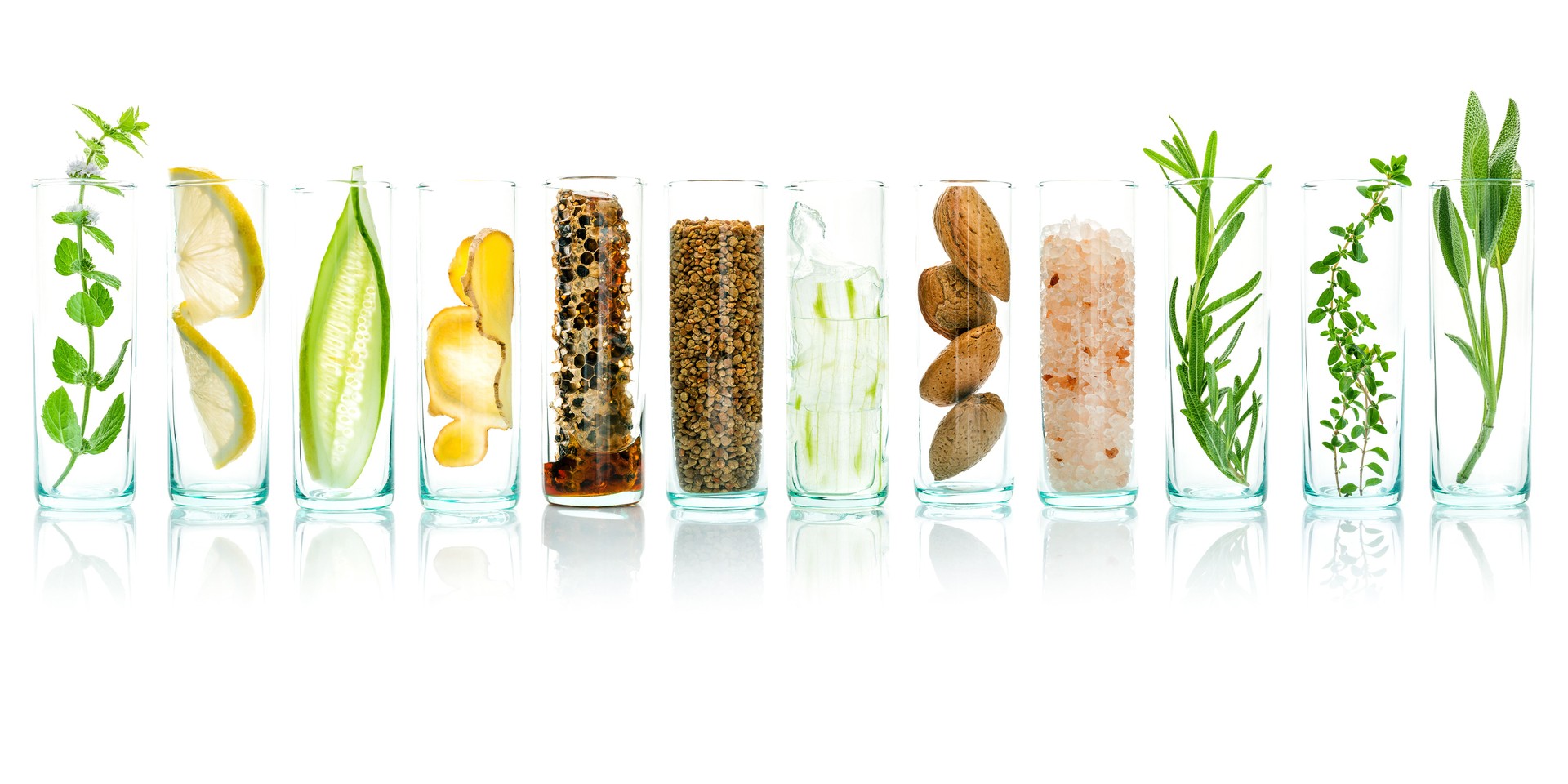 Homemade skin care with natural ingredients aloe vera, lemon, cucumber, himalayan salt, peppermint, rosemary, almonds, cucumber, ginger and honey pollen isolated on white background.
